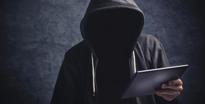 Photo of a hacker with laptop